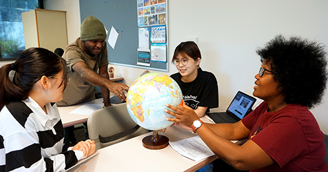 Students looking at globe